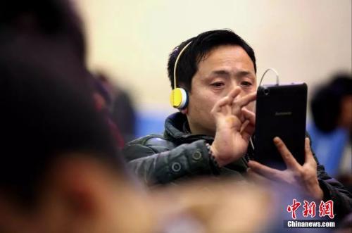 資料圖：候車室內，玩手機的&ldquo;低頭族&rdquo;隨處可見。刷微博、聊微信、玩游戲、看電影，高科技將大多旅客變?yōu)槭謾C&ldquo;低頭族&rdquo;。<a target='_blank' ><p  align=